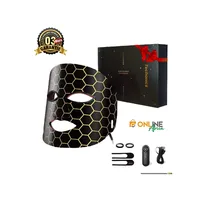 Masque de thérapie faciale LED 7 couleurs Technonics, design hexagonal noir et or, présenté avec sa boîte, sa télécommande et ses accessoires