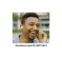 Personne souriante portant les écouteurs sans fil UBIT UB-2 pendant un appel téléphonique en extérieur