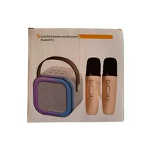 Vue du carton d'emballage du Kit Karaoké Enfant portable K12 rose comprenant deux microphones sans fil et une enceinte Bluetooth