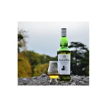 BLACK & WHITE servi dans un verre avec glaçons sur fond bois