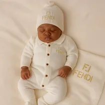 Détail de la couverture de naissance Fendi en coton doux couleur crème.
