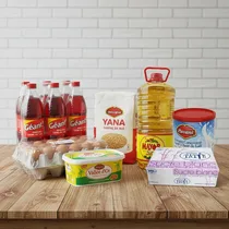 1. Pack alimentaire Ramadan complet avec huile Mayor, farine Yana et œufs sur table en bois