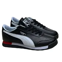 Baskets Puma Jogger noir blanc avec détail rouge vue de profil